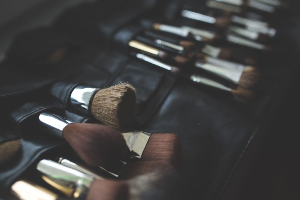 A stylish arrangement of makeup brushes set against a dark, elegant background.