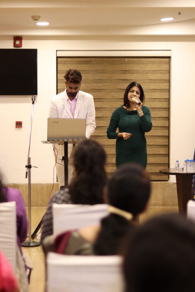 Business professionals presenting at a corporate event in Ahmedabad, India.