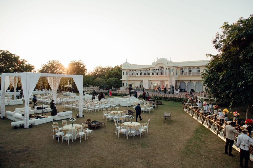 A luxurious outdoor wedding setup at a grand villa during sunset, showcasing elegance and opulence.
